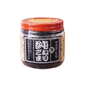 Jar of black sesame paste with a red lid on a white background