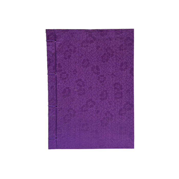 Purple notebook with a subtle pattern on a white background