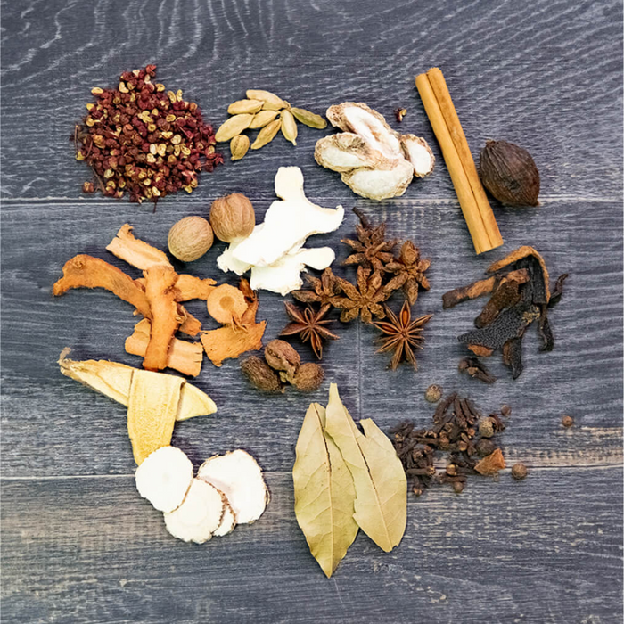 Assorted spices and herbs on a wooden surface